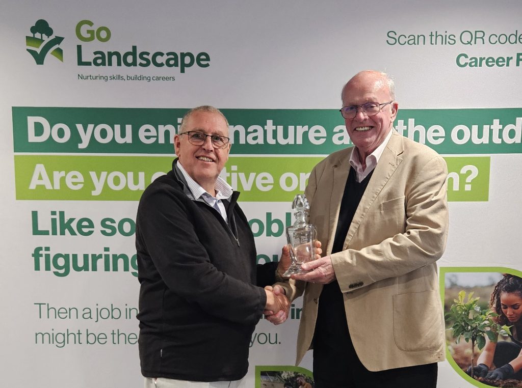 Incoming Chair Nick Coslett (L) presents gift to outgoing Chair Peter Jennins (R)